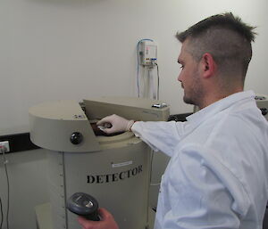 Technician places sample into detector