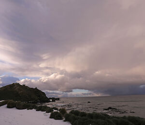 Snow clouds and isthmus beach