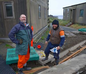 Two expeditioners beside completed pipe work