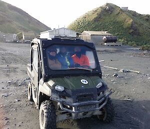 Three expeditioners in a small 4 wheel drive vehicle