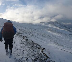 Expeditioner walking along snow covered track