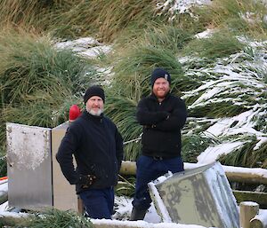 Two expeditioners working in a plumbing pit