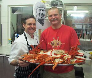 chef, cardboard cut out Mawson, and expeditioner with plate of crayfish