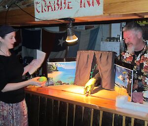 Two expeditioers enact a tuatara hand and finger puppet