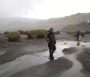 Expeditioner walking on foggy beach