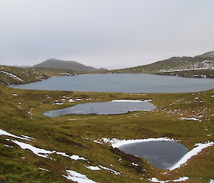 Windy Ridge Lake and MIPEP (Macquarie Island Pest Eradication Project) hut as viewed from the overland track