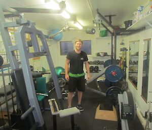 An expeditioner stands in the weight training room