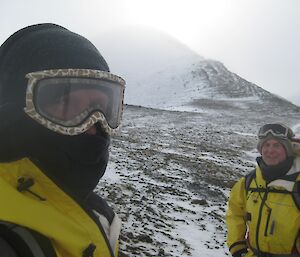 Macca expeditioners with snowy hill behind