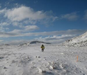 Walking back from Green Gorge, an expeditioner in full gear is surrounded by snow