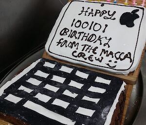 Birthday cake that looks like a laptop with some binary code in the message