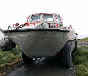 Parked LARC vehicle showing the boat body and large wheels for beach landings