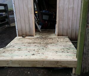 Cold porch being constructed shows raw wood installed