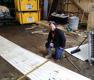 Greg posing in front of corrugated iron which he will cut to size for a new cold porch