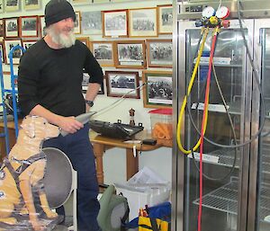 Replica Stay supervises Paul while he repairs the mess refrigerator