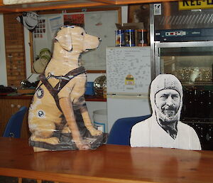 Replica Stay cardboard cutout dog with Sir Douglas Mawson cardboard cutout at a dinner table