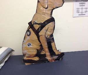 A cardboard cutout replica printed with a likeness of a plastic labrador donation dog