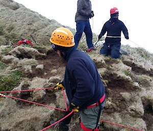 Expeditioners managing the main line and belay systems