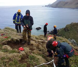 Expeditioners preparing for the lowering of the patient down the slope