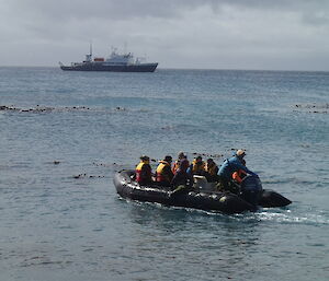 Returning rangers fill an inflatable rubber boat