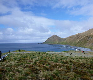 Tourists at use a walking track near the seaside at Sandy Bay