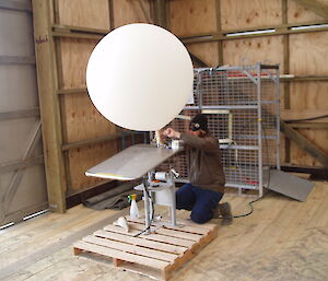 Bureau of Meteorology technician Sean fills a weather sonde balloon with inert helium