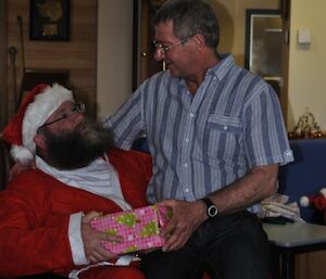 Santa gives male expeditoner his present