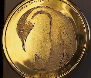 A beautiful and first class brass etching of an emperor penguin and chick