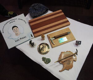 The magnificent presents made on Station featured bread boards, wooden penguin, a brass etching of an emperor penguin and a miniature ice axe on a wooden map of Antarctica