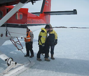 As the Director stepped down from the plane onto the sea ice the Station Leader welcomes him to Mawson