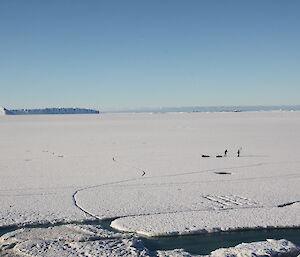 Two expeditioners skiing on the sea ice back to station after delivering essential supplies to the scientists on Bechervaise Island