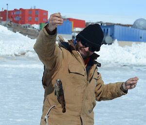 Expeditioner holds up the largest catch of the day which was still quite small