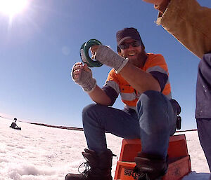 Expeditioner smiling whilst fishing