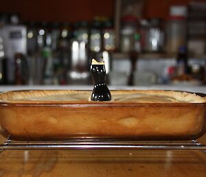 A pie with a pie bird in a dish on a stand