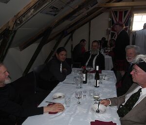 Fie expeditioners sitting at a table after finishing dessert