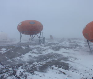 Through the reduced visibility of the blizzard the image of the Googie accommodation is just visible