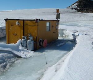 A field hut in ice following a large summer melt