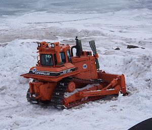 Expeditioner in D7 dozer pushing snow