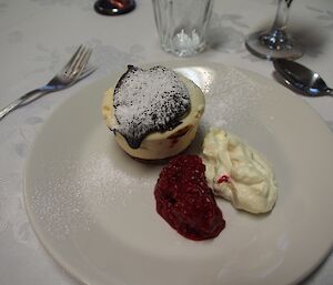 Mini Baileys cheesecake with raspberry coulis and cream