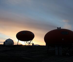 A sunset shot with the smartie shaped huts and Apple shelter silhouetted in the foreground