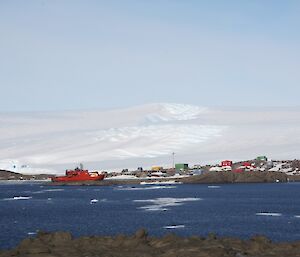 The orange Sip in Horseshoe Harbour with Mawson and ice plateau behind