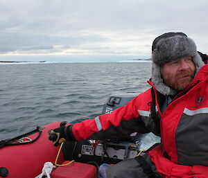 Craig Hayhow in an inflatable boat steering the rudder