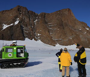 Mt Parsons west face with Hägglunds and expeditioners in foreground