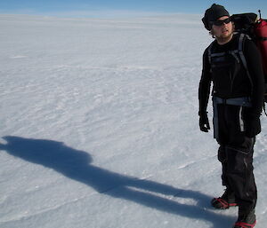 Keldyn F on plateau, gazing to the right with snow and ice all around him