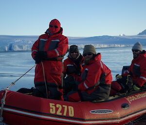 Cliff, Craig, Jeremy and Peter C pose in an inflatable rubber boat with water and ice plateau in background