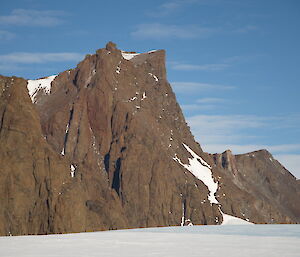 Mt Parsons, an imposing rocky peak juts out from snow