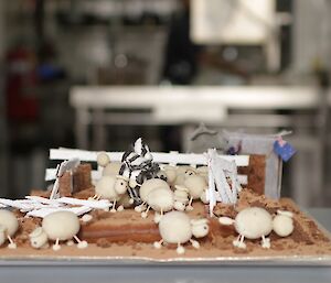 Farm cake showing sheep and a fence atop a chocolate cake