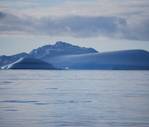 Iceberg that looks like a whale coming out of the water