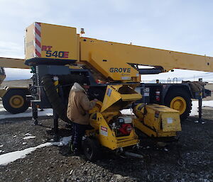 An expeditioner prepares to operate a very large crane