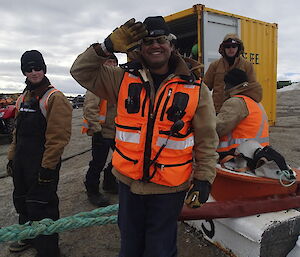 Cliff Simpson at Davis poses in full gear including safety vest while he salutes the photographer