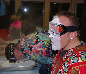 An expeditioner has flour on his face during quiz game